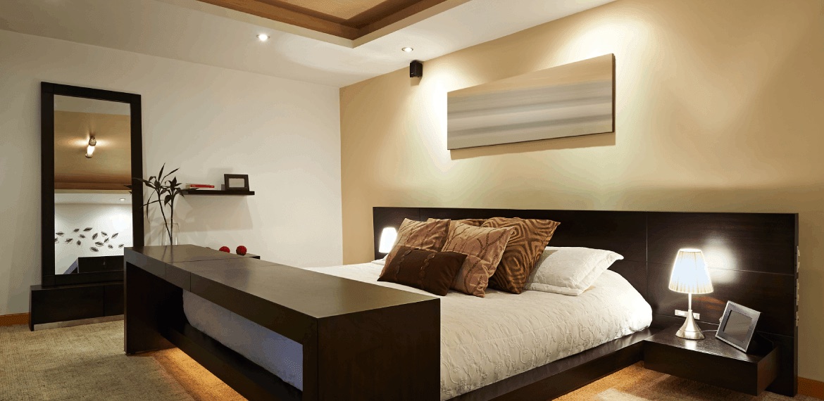 Bedroom with soft cream walls and dark wood furniture