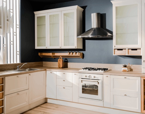 Kitchen with white painted cabinets against a deep blue feature wall